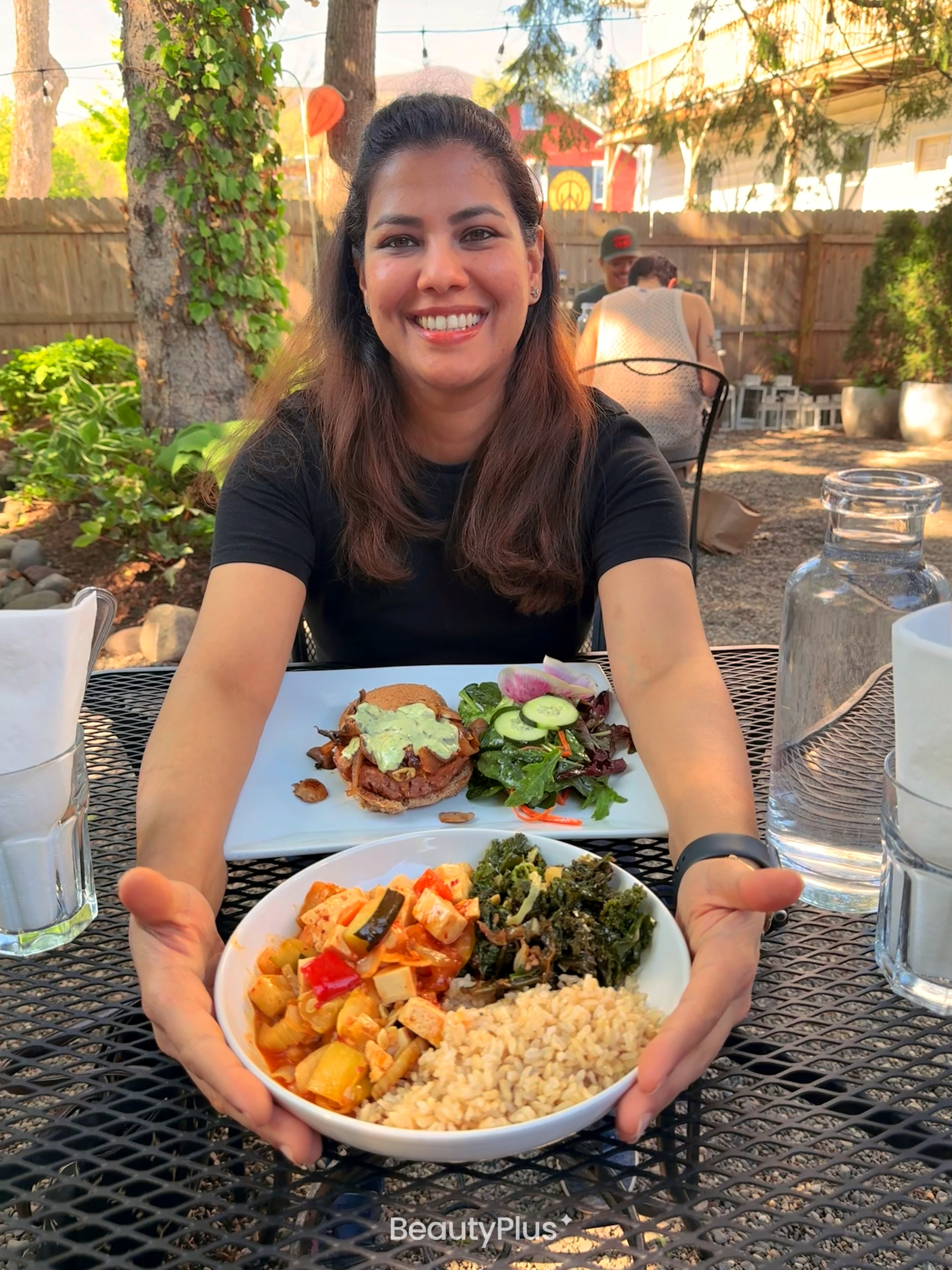 Surabhi Mendiratta smiling at an outdoor table